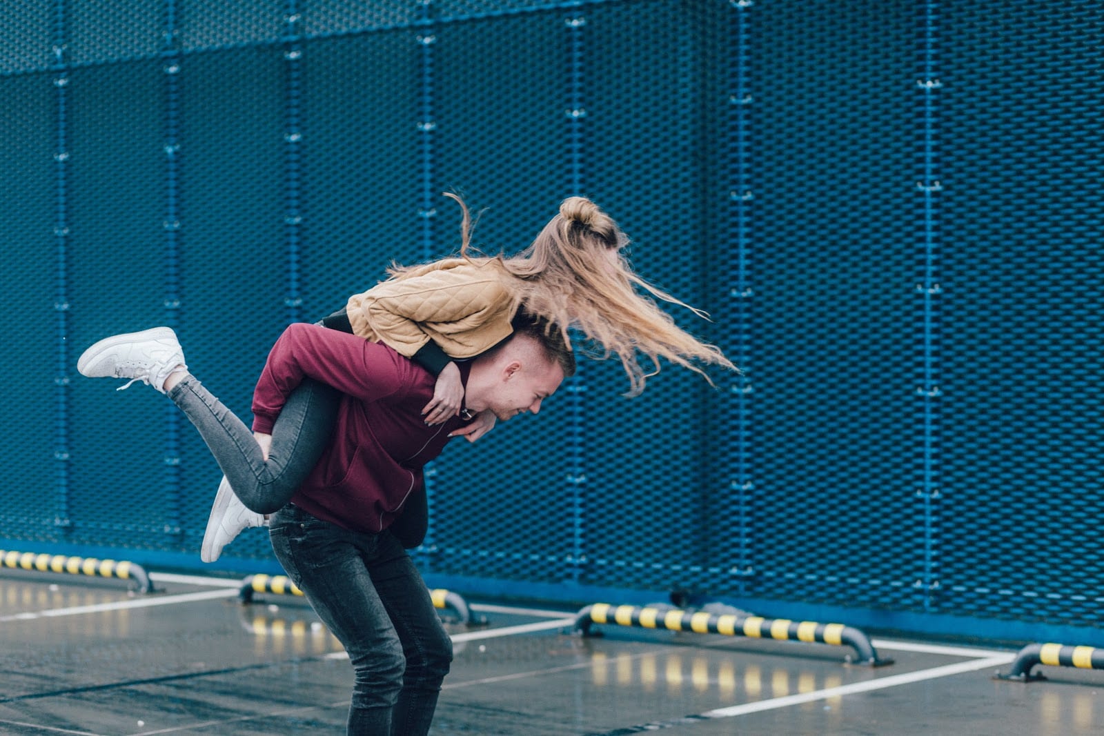 A young couple engaged in a piggy back ride